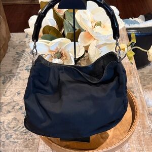 Gucci Nylon hobo bag featuring a signature bamboo top handle